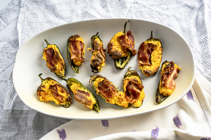 Jalapeno poppers on a off white oval plate