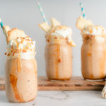 Peach Cobbler shake with three shakes. Blue and white straws sticking out from the shakes. 