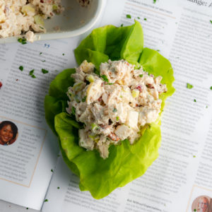 chicken salad in a lettuce cup on a news paper