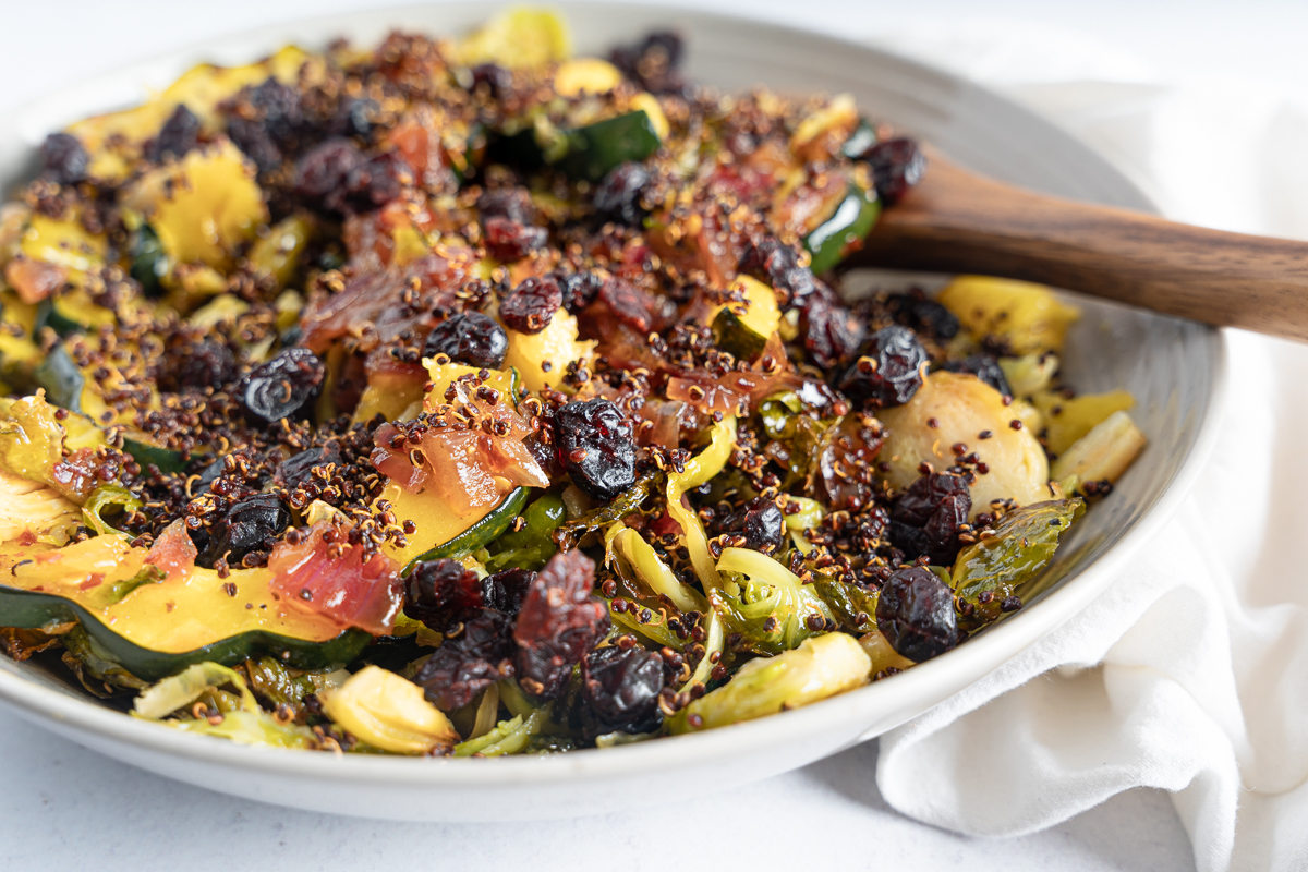 Hot Brussels Sprout Salad close up with a wooden spoon