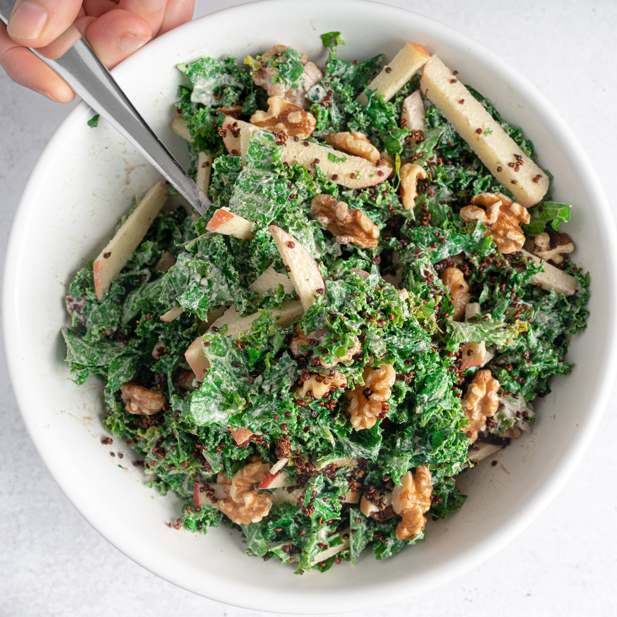 This is an image of a Kale Apple Walnut Salad