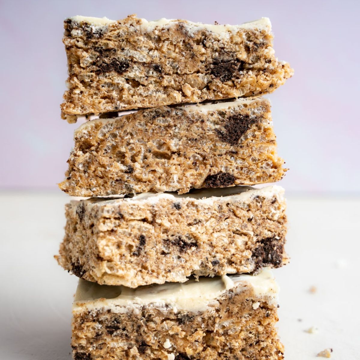 Four Stacked Cookies and Cream protein bars with white chocolate coating on the top