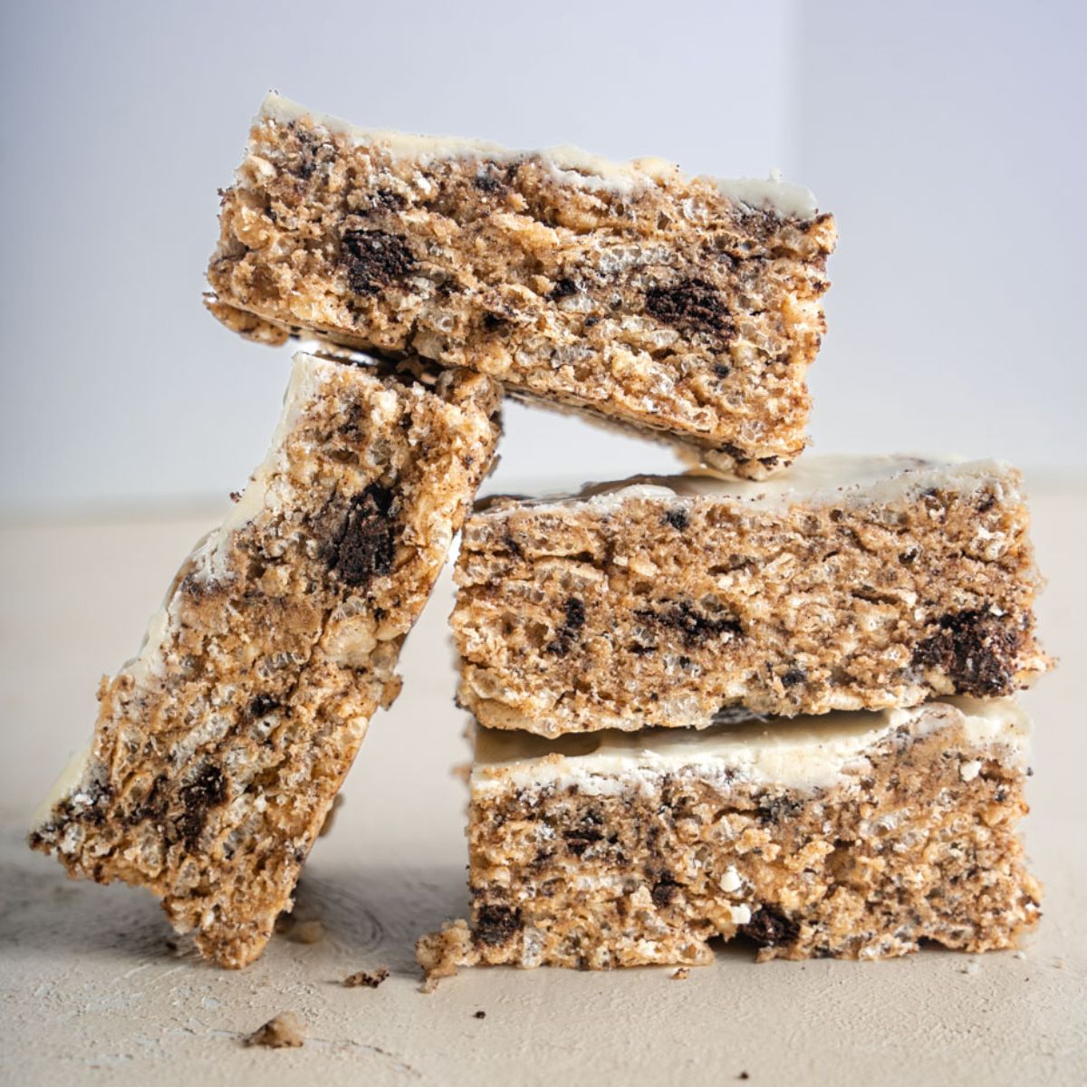 Stacked Cookies and Cream Protein Bars with pink backdrop