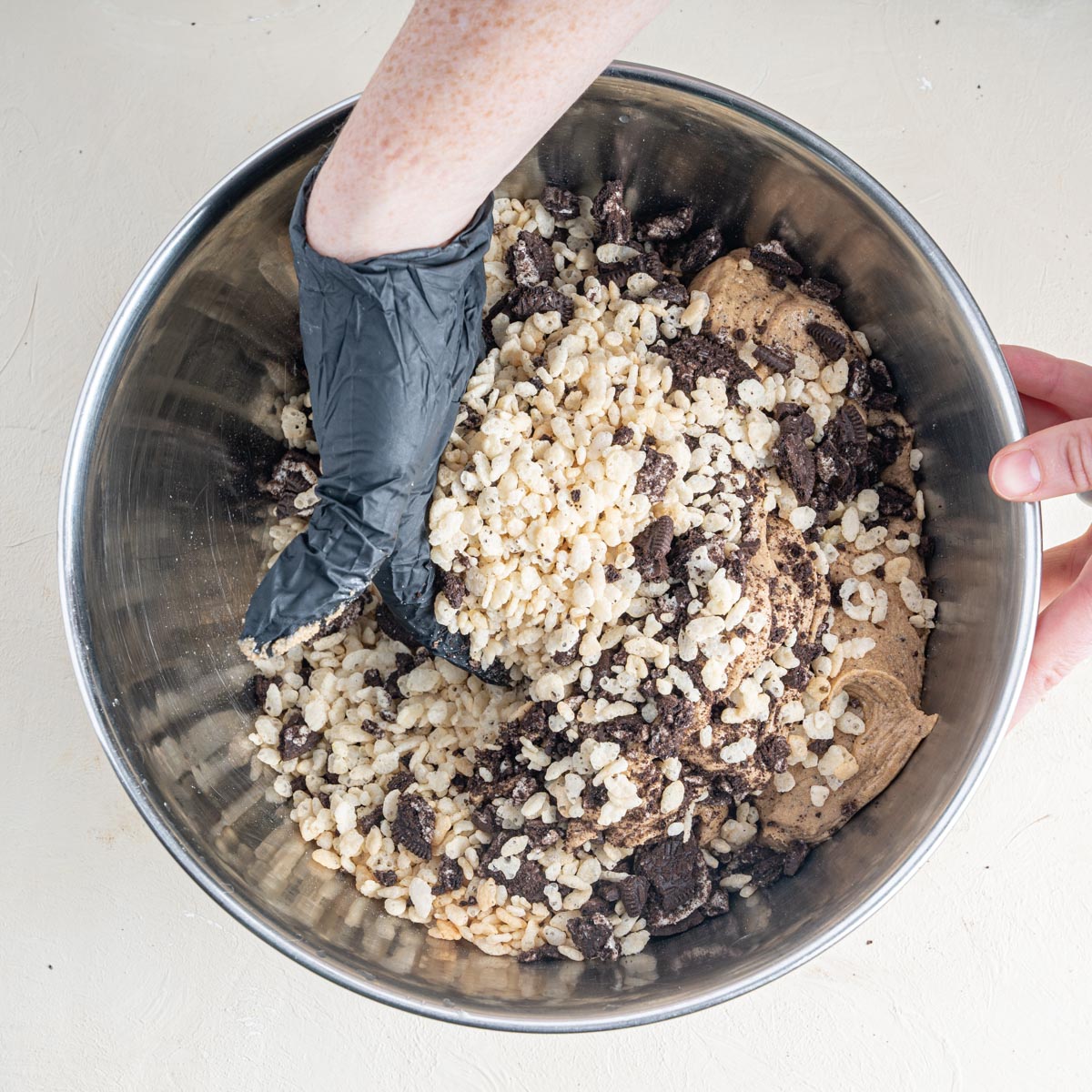 Stirring by hand the ingredients for a cookies and cream protein bar