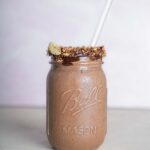 Almond-Joy-Smoothie in mason jar with pink background
