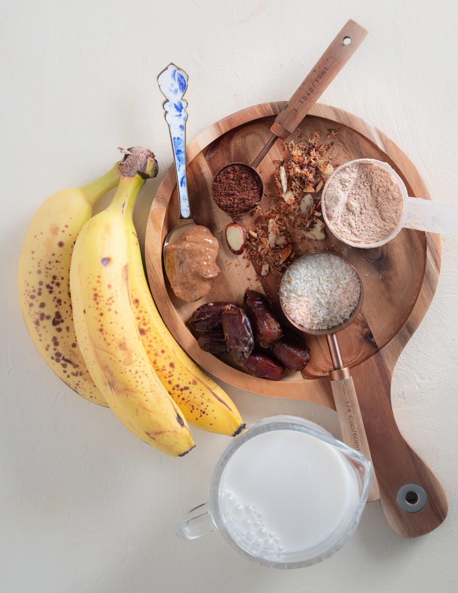 Smoothie ingredients laid out on a wooden platter.