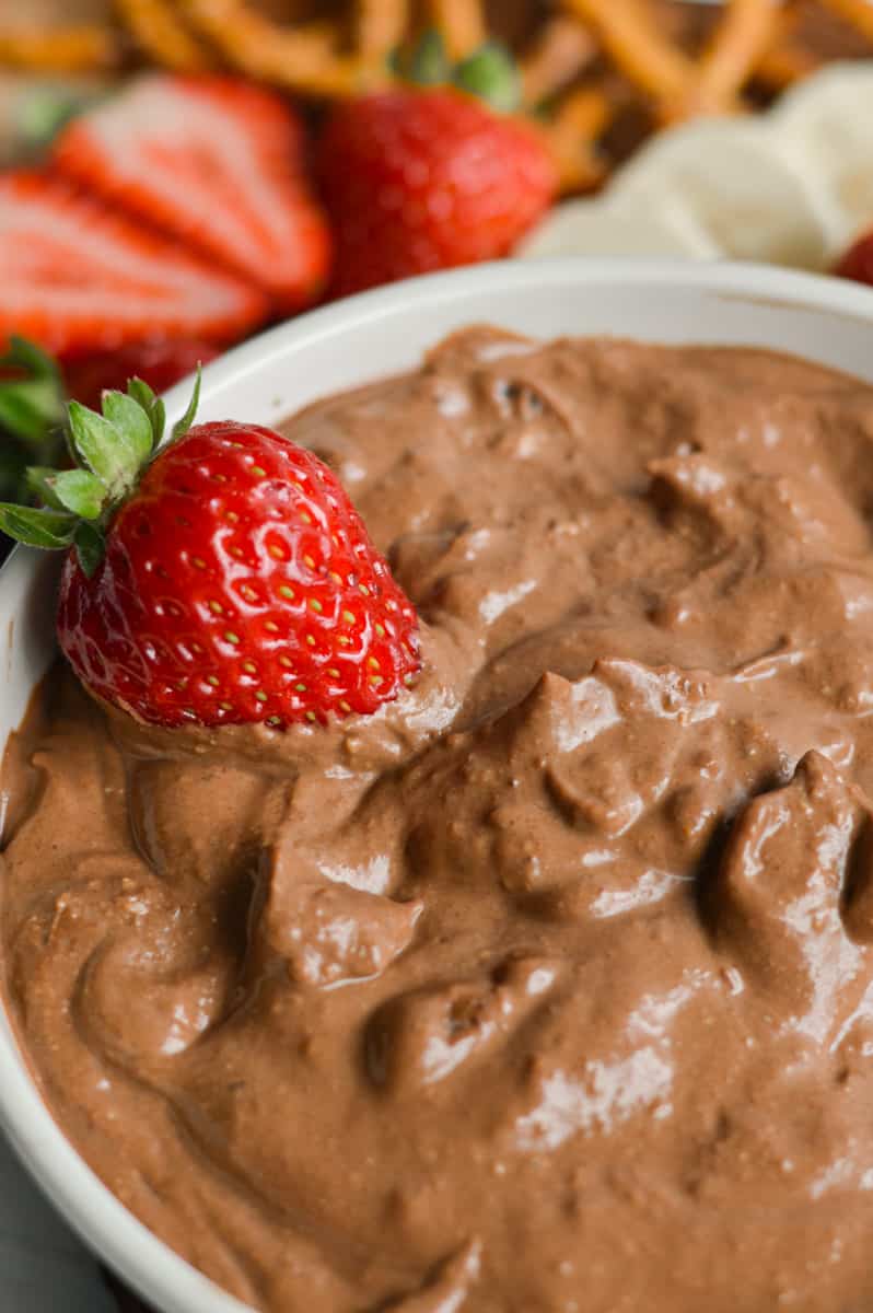 Chocolate Vegan Fruit Dip with a strawberry garnish. 