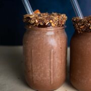 Chocolate Smoothie with a toasted nut rim against a dark block backdrop.