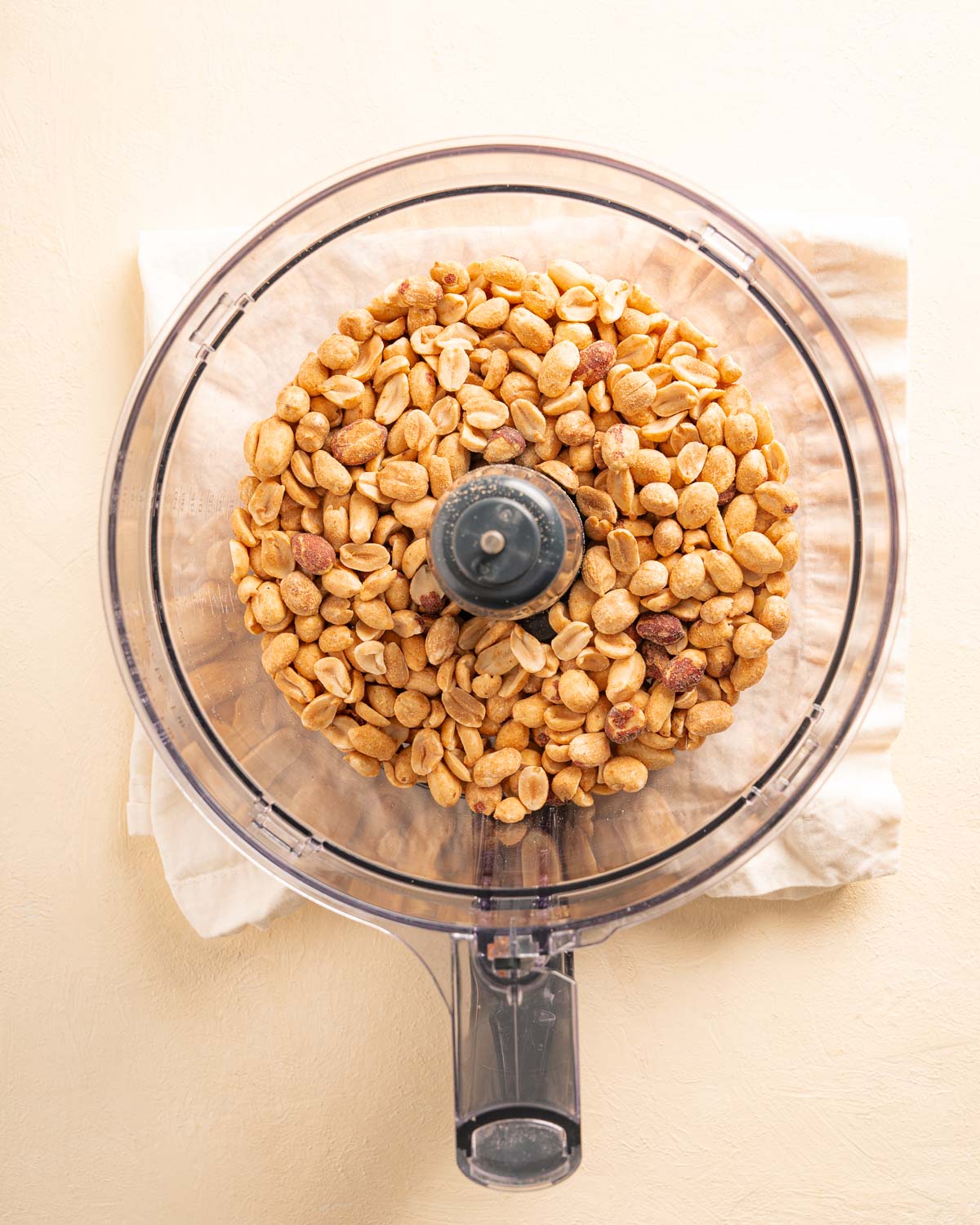 A food processor filled with peanuts