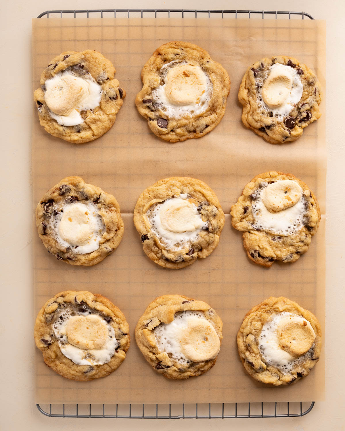 top down of cookies on a cooling wrack over brown parchment paper
