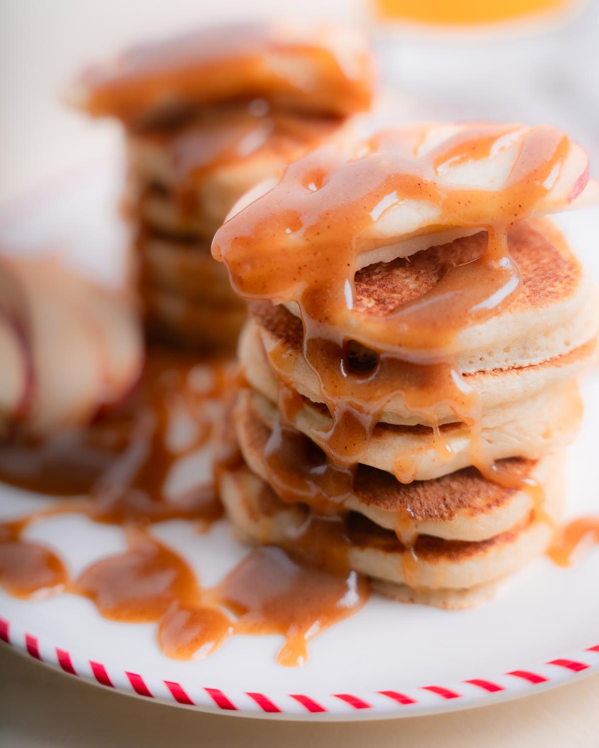 stacked mini pancakes with maple peanut butter drizzle