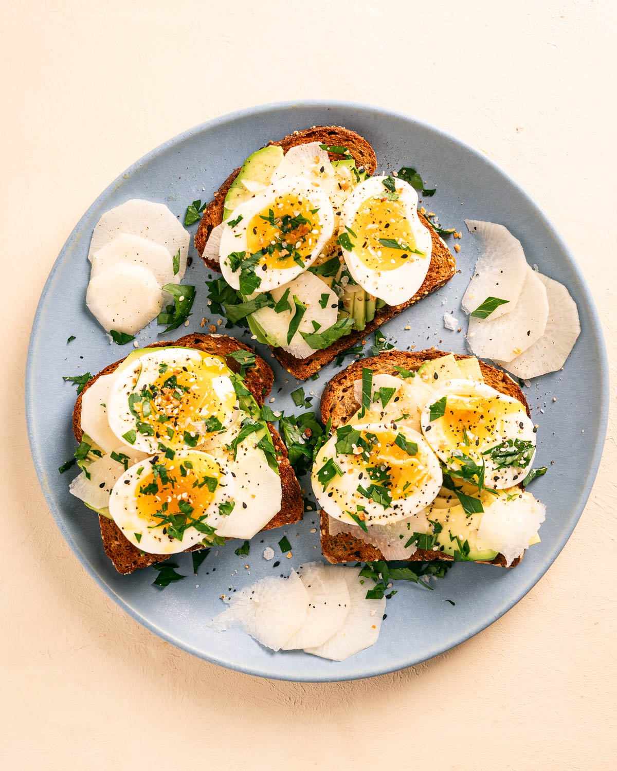 Soft Boiled Eggs on Toast with Sliced Turnips on a blue plate