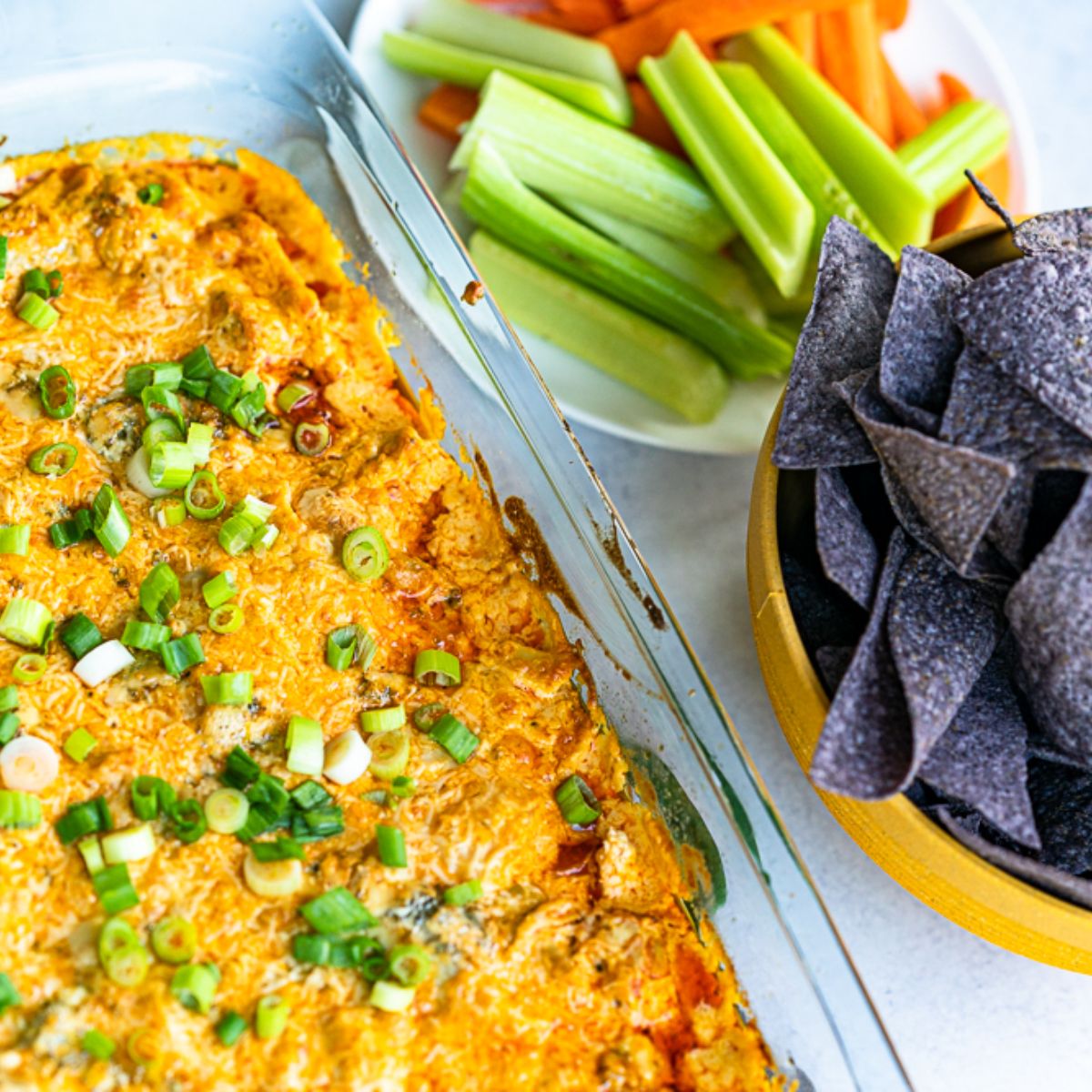 A quart baking pan with freshly baked Franks Red Hot Buffalo Chicken Dip with dippers