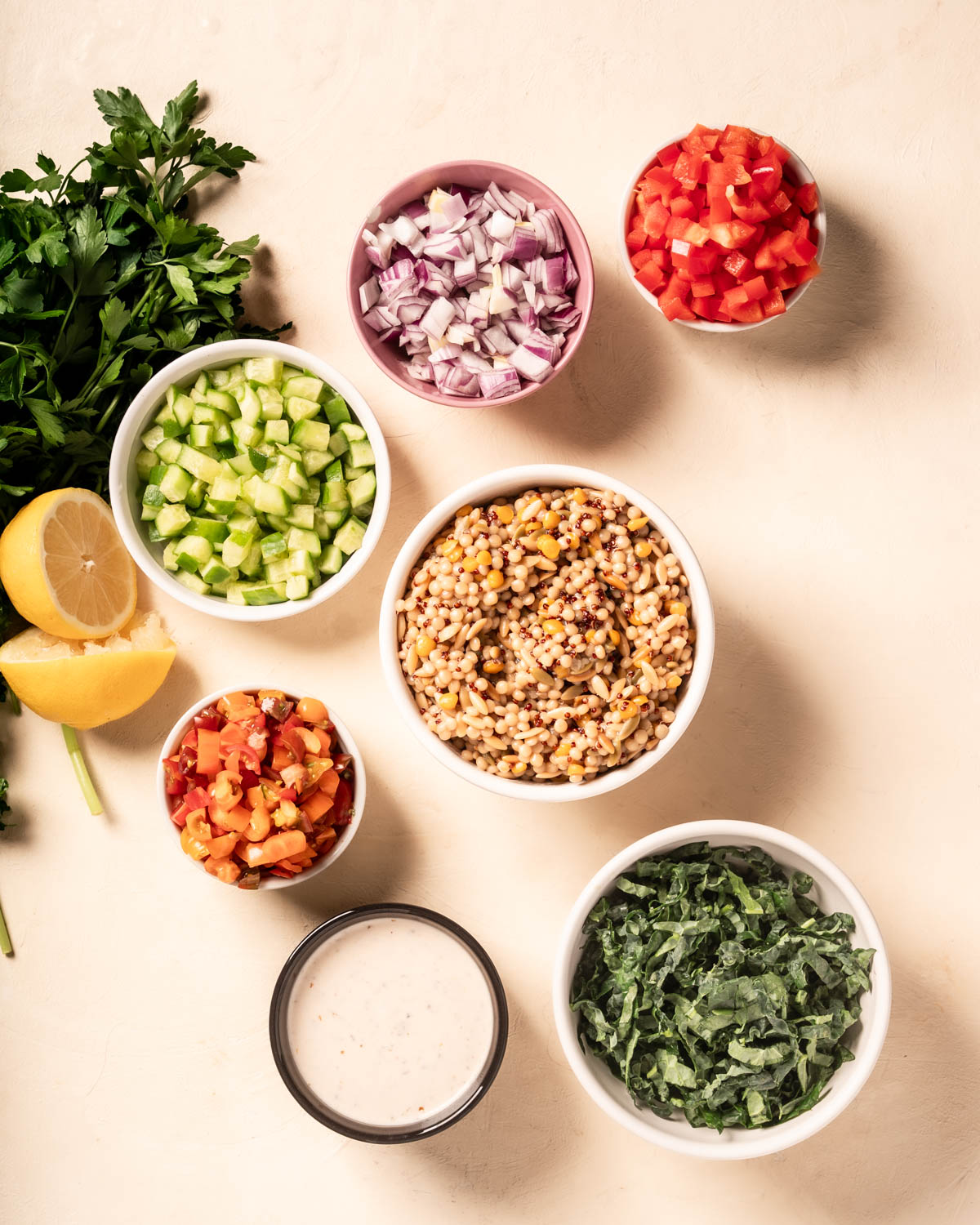 Ingredients in small bowls for Greek Salad Grain Bowls