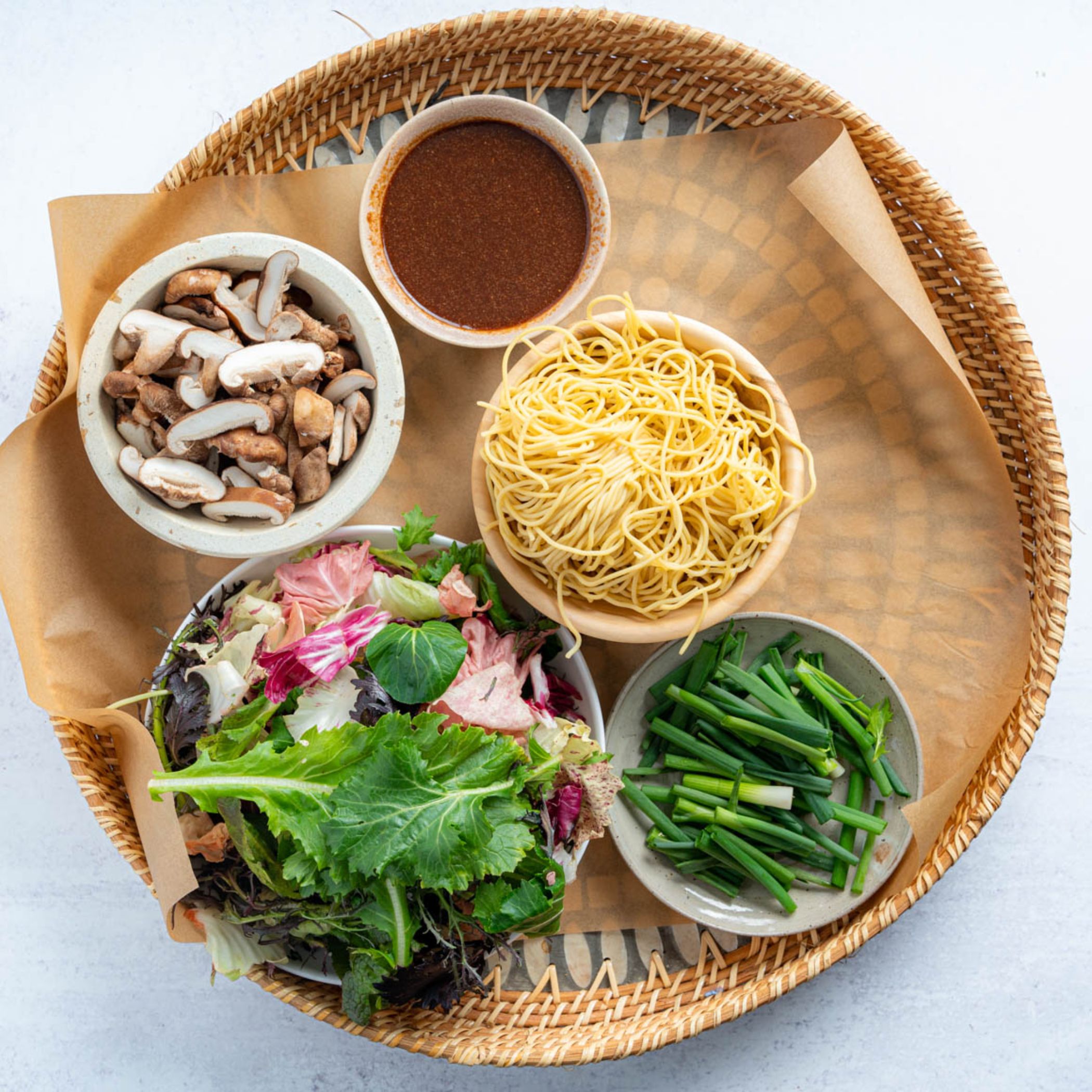 ingredients on a platter in small bowls for vegan yakisoba recipe